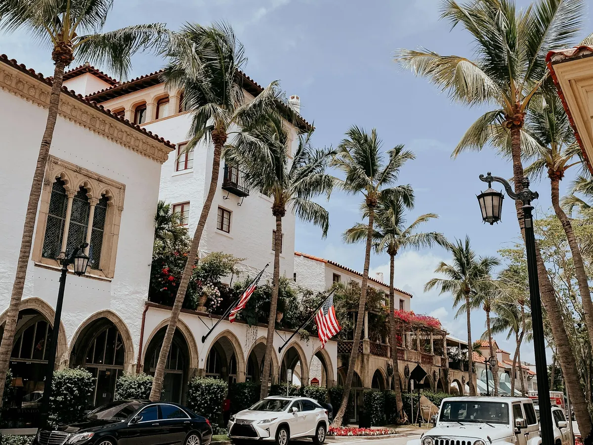 Palm-lined street with Spanish-style arcades in Palm Beach