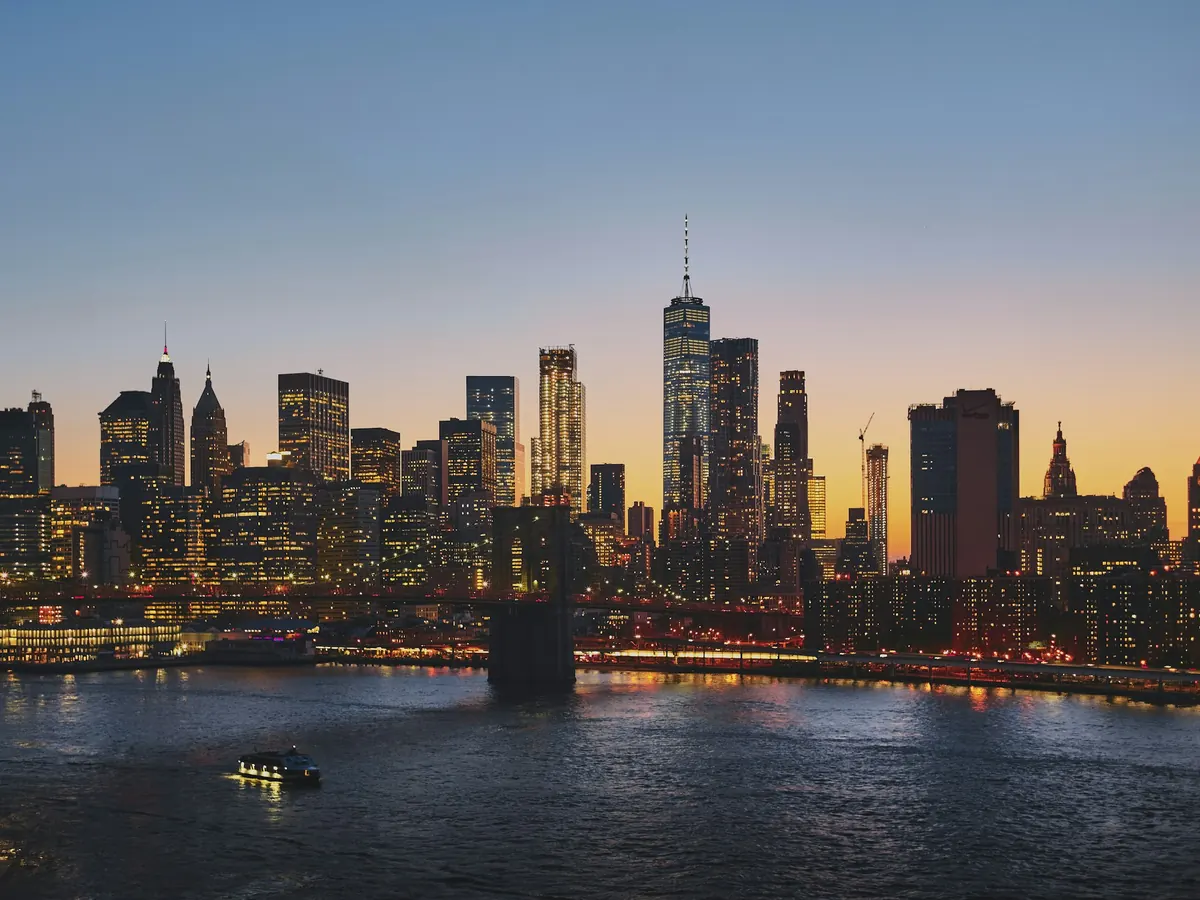 Manhattan skyline across the water at dusk